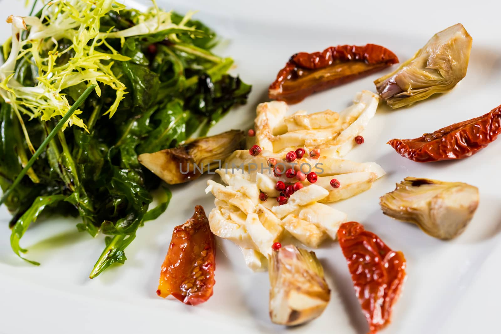 Fresh salad with sun-dried tomatoes and cheese in the Italian style. Healthy Food