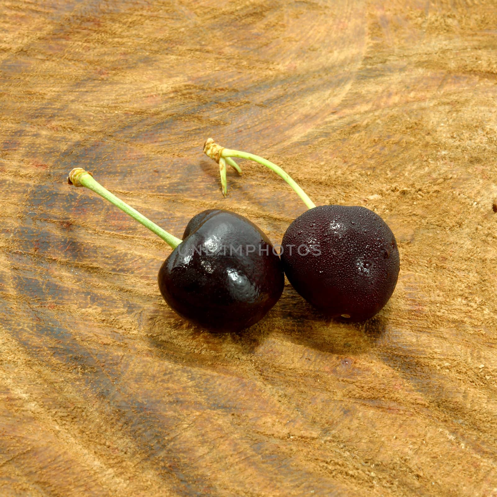 Black cherry on wood by Noppharat_th