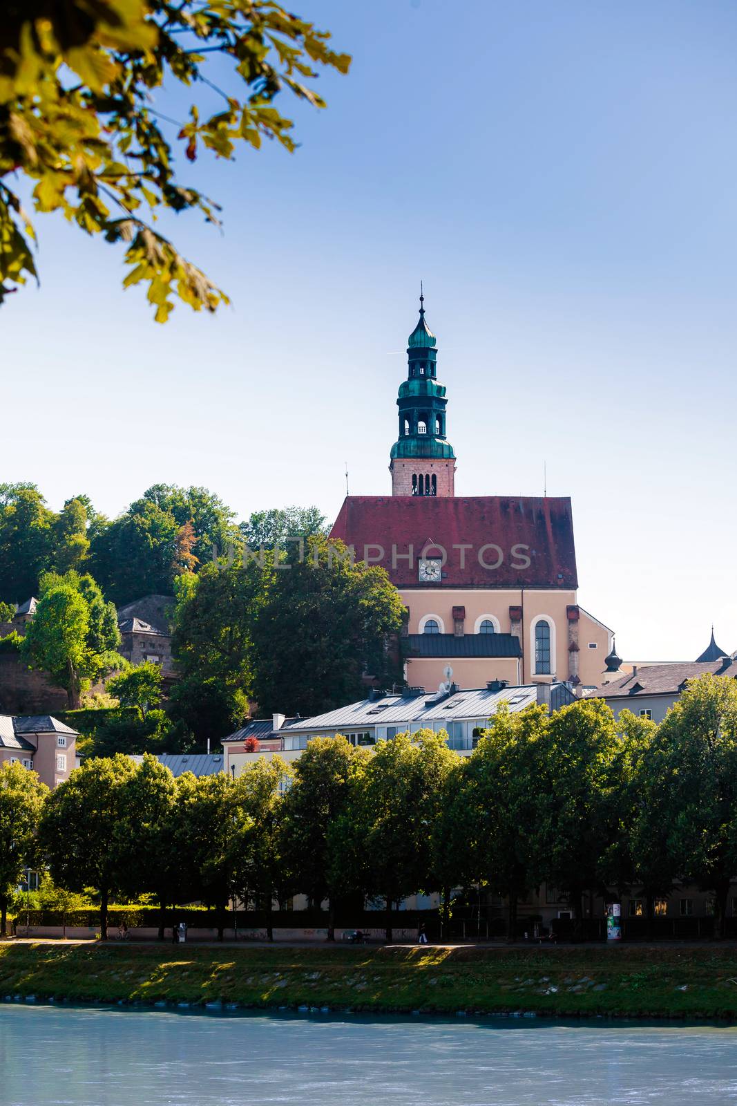 Hallstatt, Austria - August 5, 2013: Pfarramt Mulln catholic church, overseeing the historical old town in Salzburg, Austria.