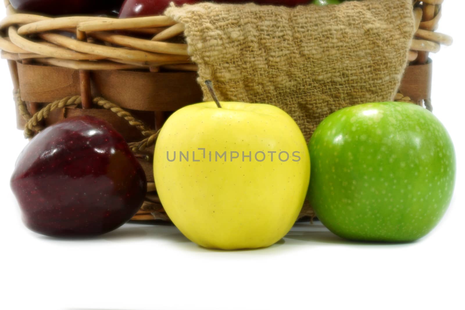 Apples in basket on a white background. by Noppharat_th