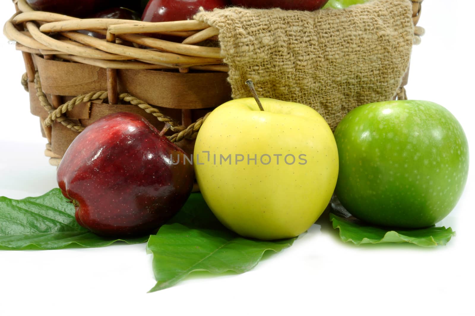 Apples in basket on a white background. by Noppharat_th