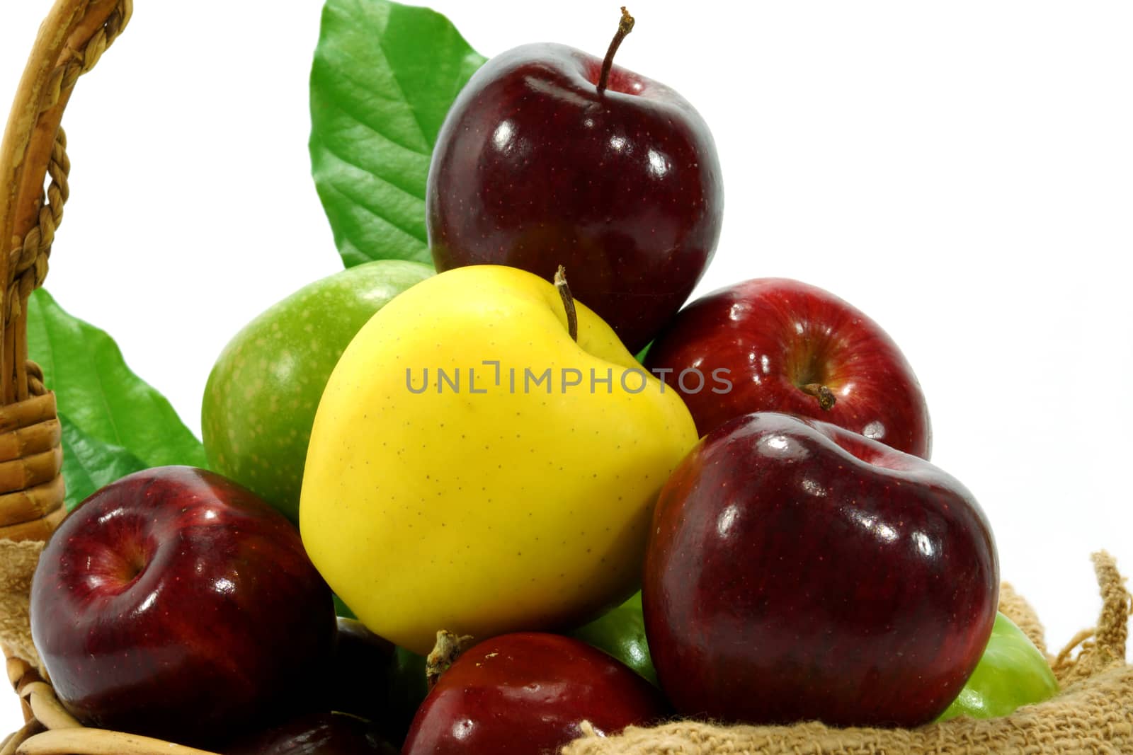 Apples in basket on a white background.