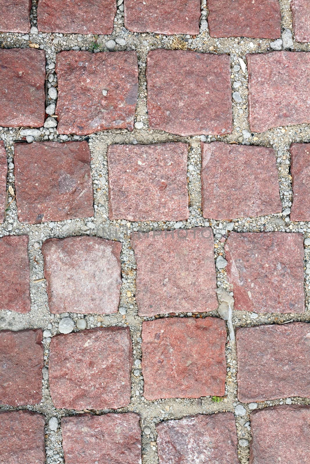 old reddish stone pavement mounted on gravel