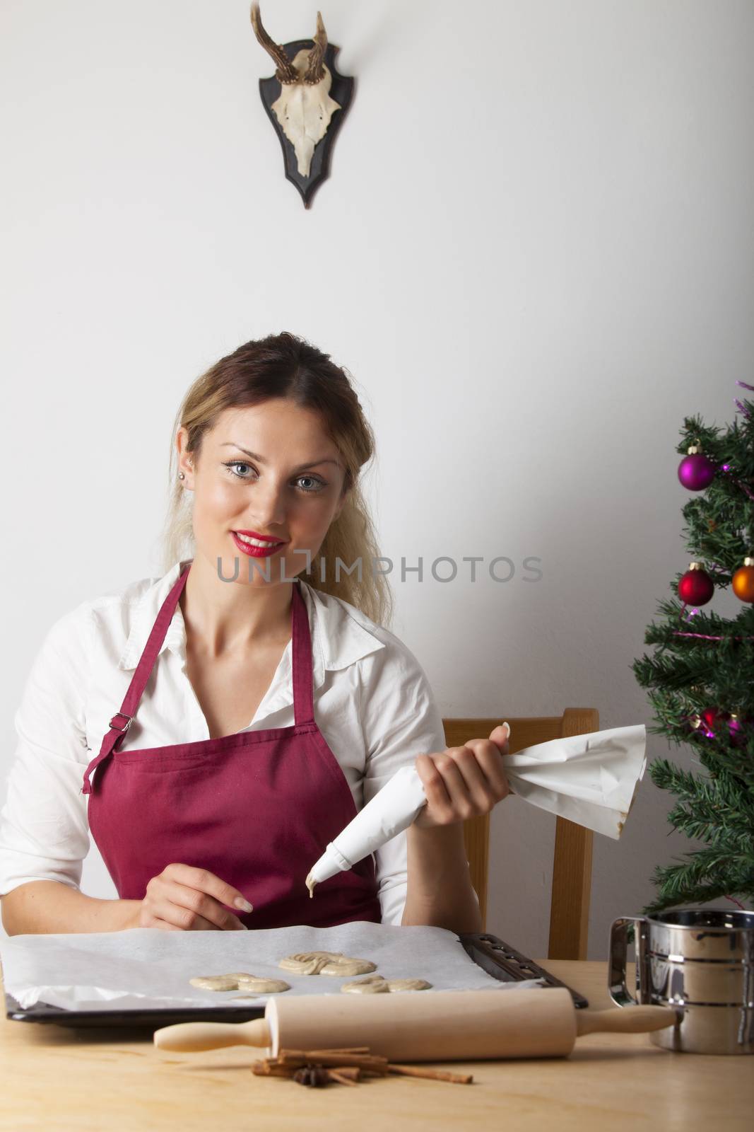 woman baking with a christmas tree