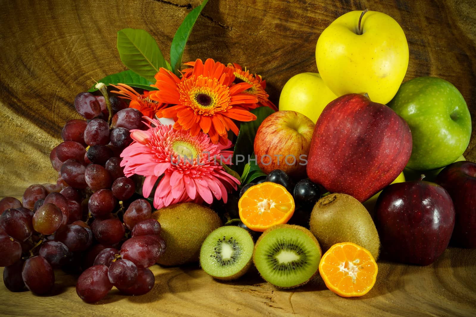 Assortment of exotic fruits on wood background. by Noppharat_th