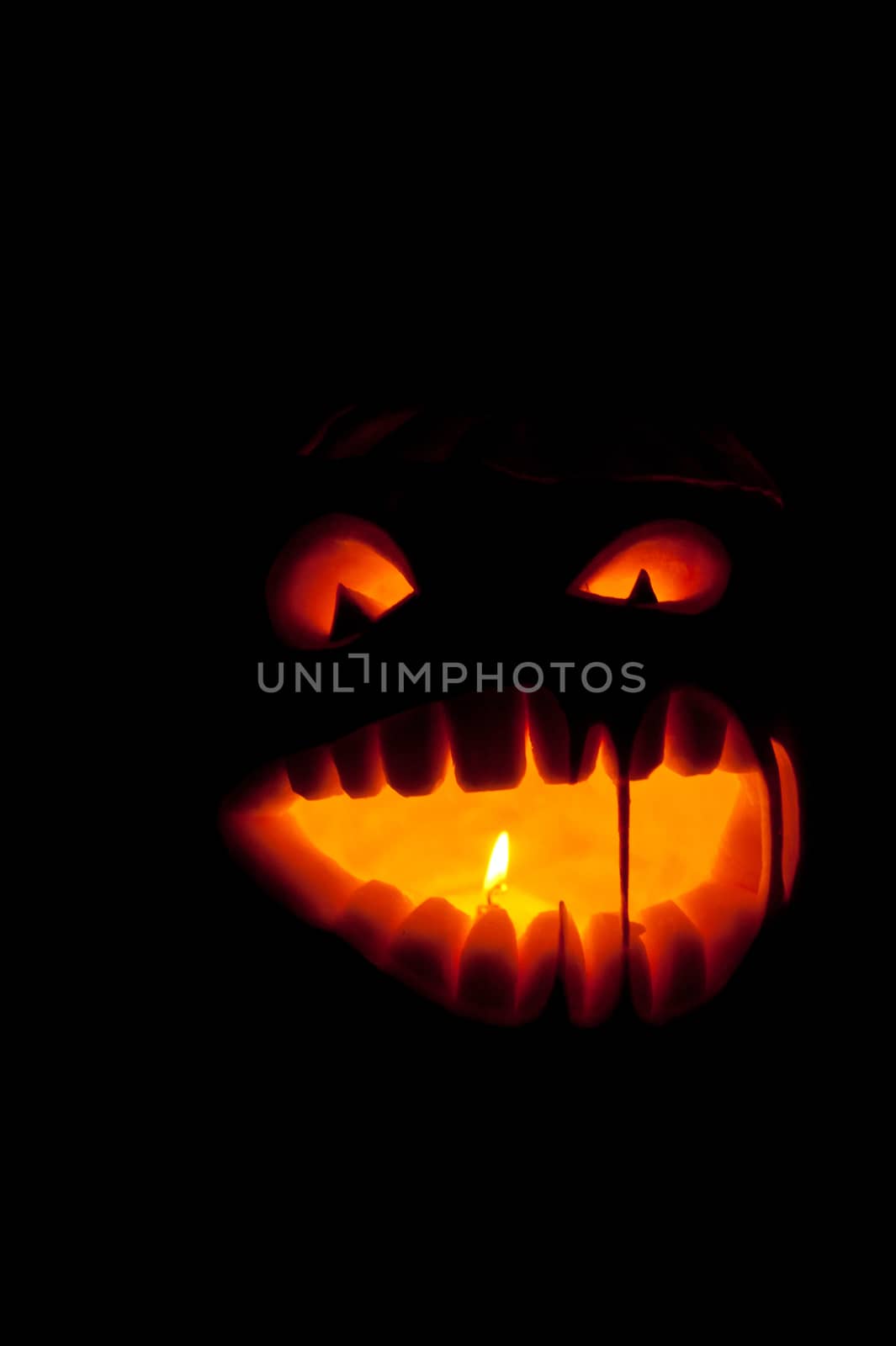 Halloween pumpkin with scary face on black backgound