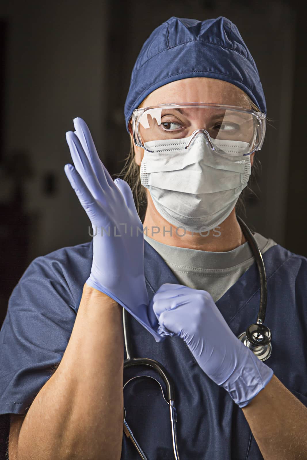Concerned Female Doctor or Nurse Putting on Protective Facial Wear and Surgical Gloves.