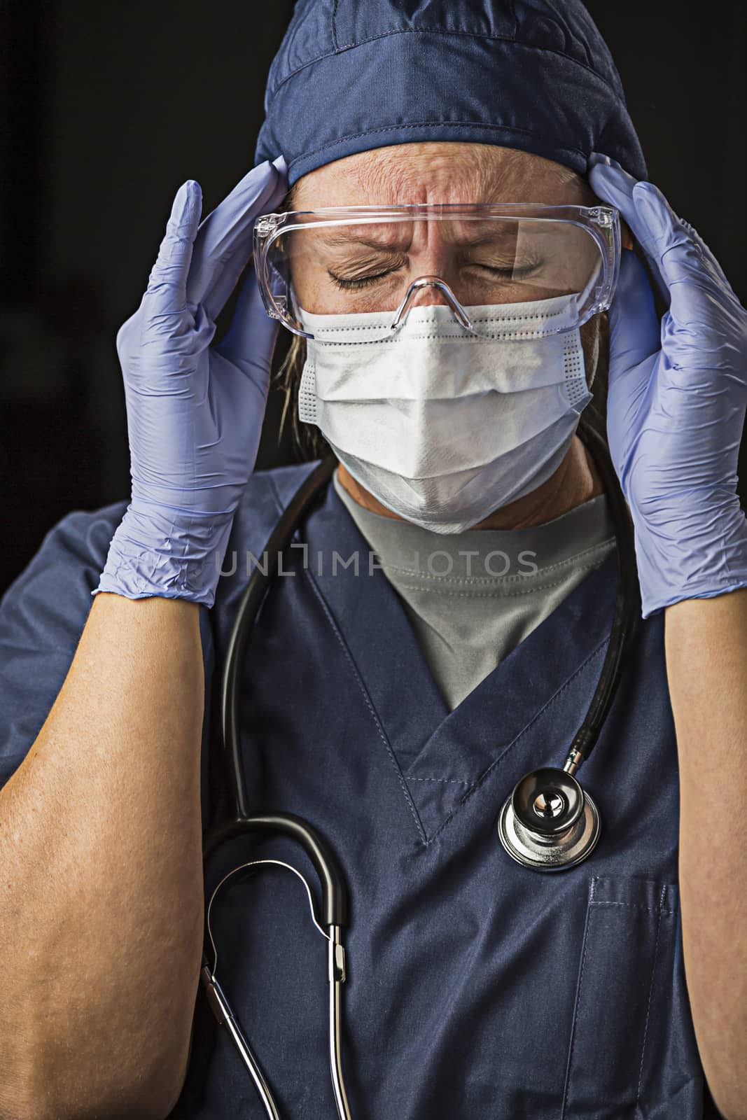 Grimacing Female Doctor or Nurse Wearing Protective Wear by Feverpitched