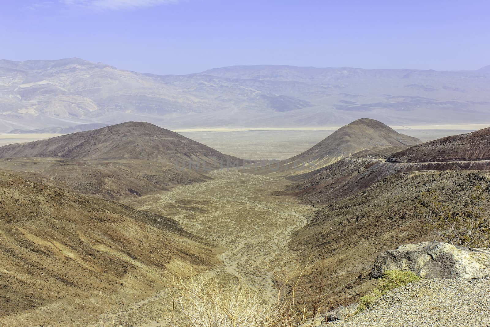 Looking down on an alluvial fan with desert and mountains in the distance