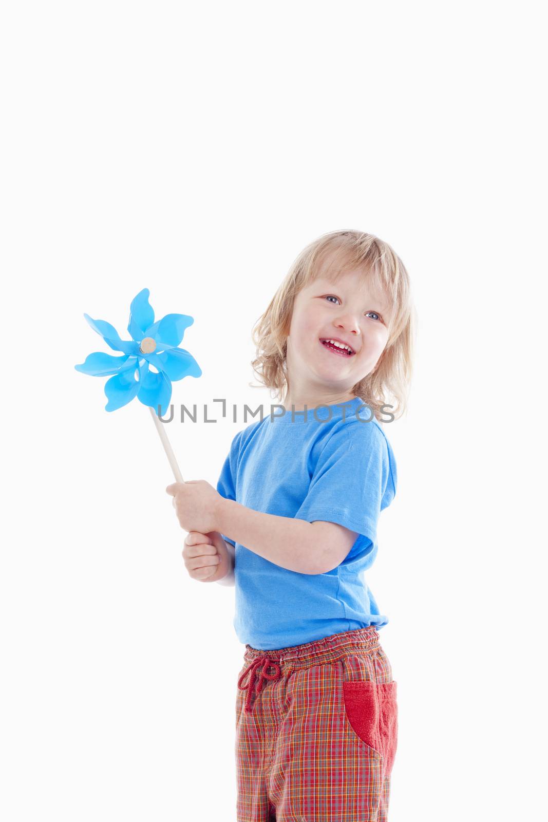 studio shot of a boy playing with pinwheel - isolated on white