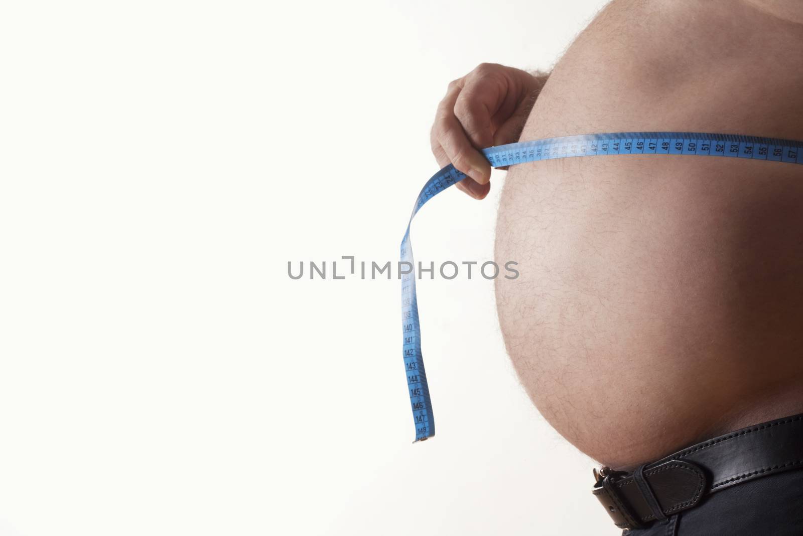 big belly of a fat man and measuring tape isolated on white