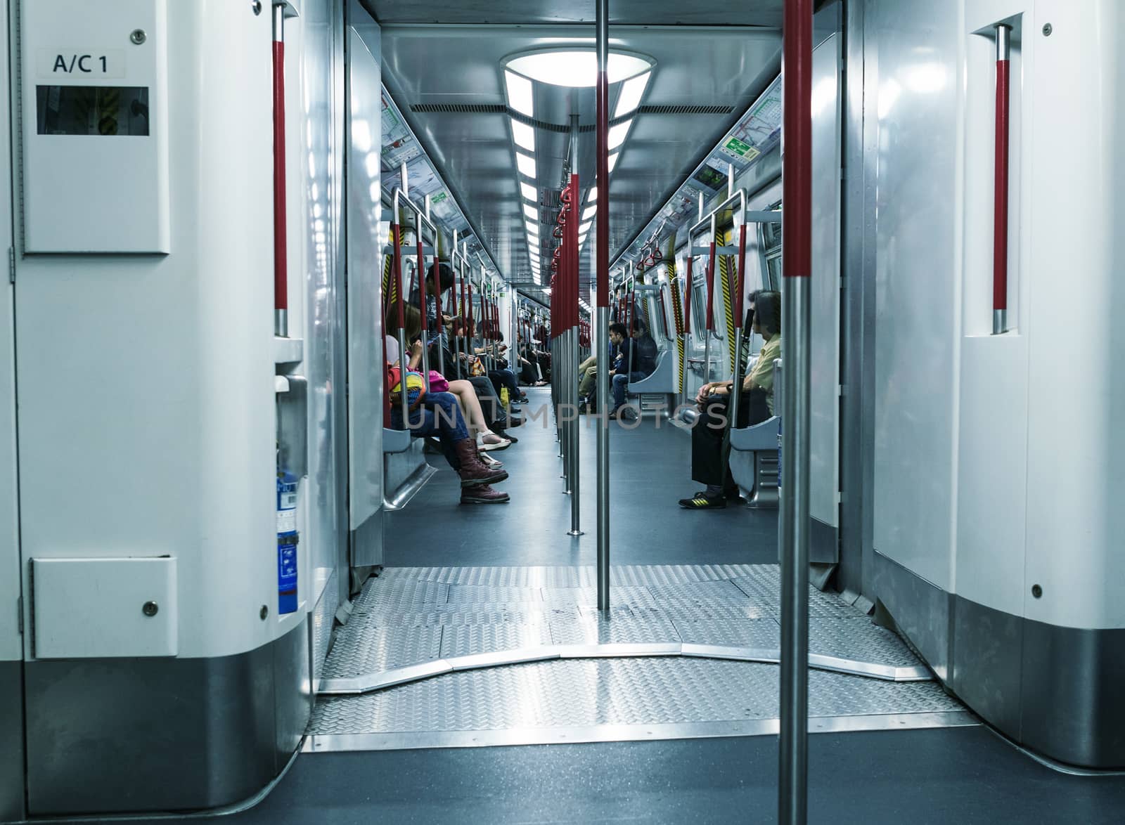 HONG KONG - APRIL 14, 2014: People in city subway train. More than 90 percent of locals use the efficient public transportation system.