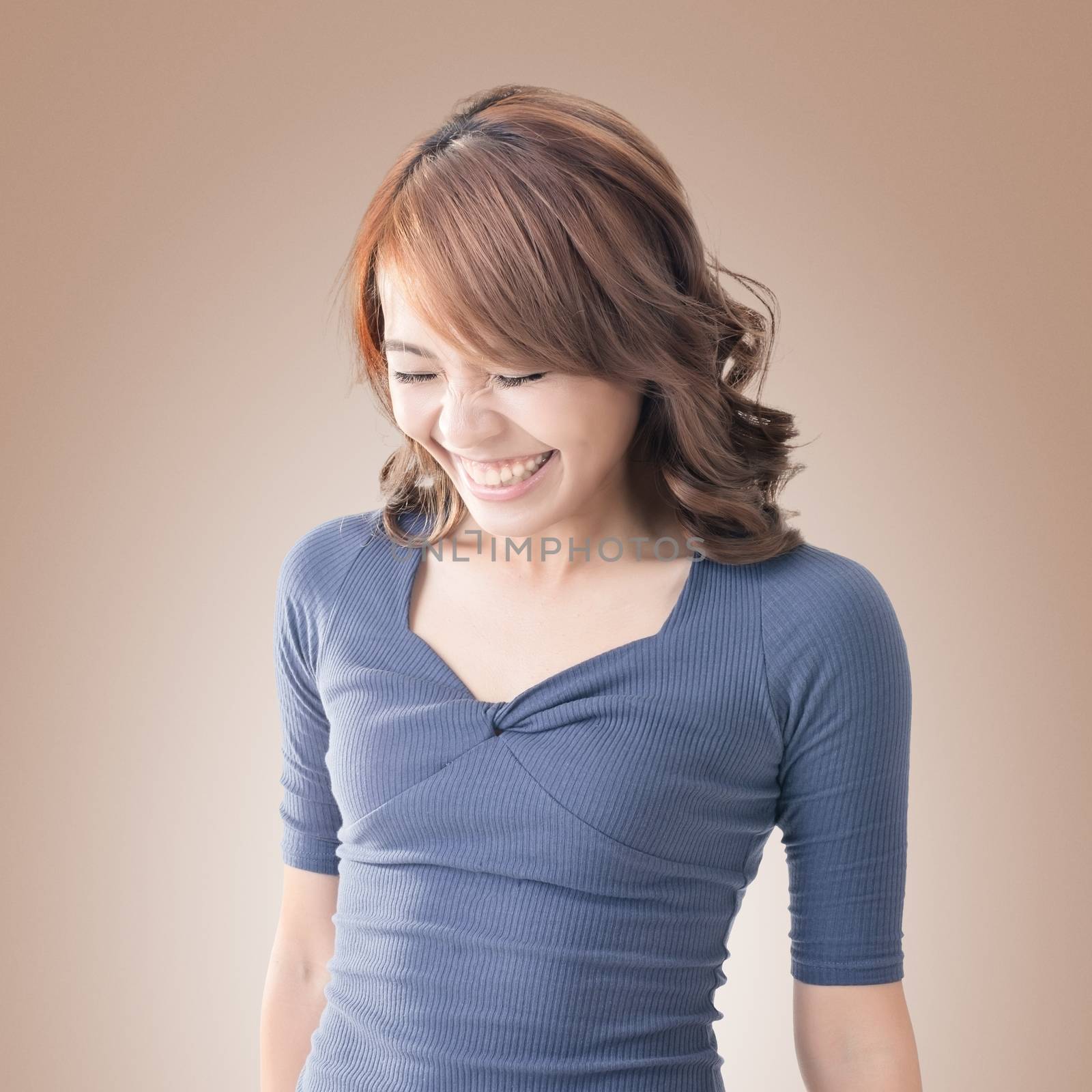 Shy Asian girl smiling, closeup portrait.