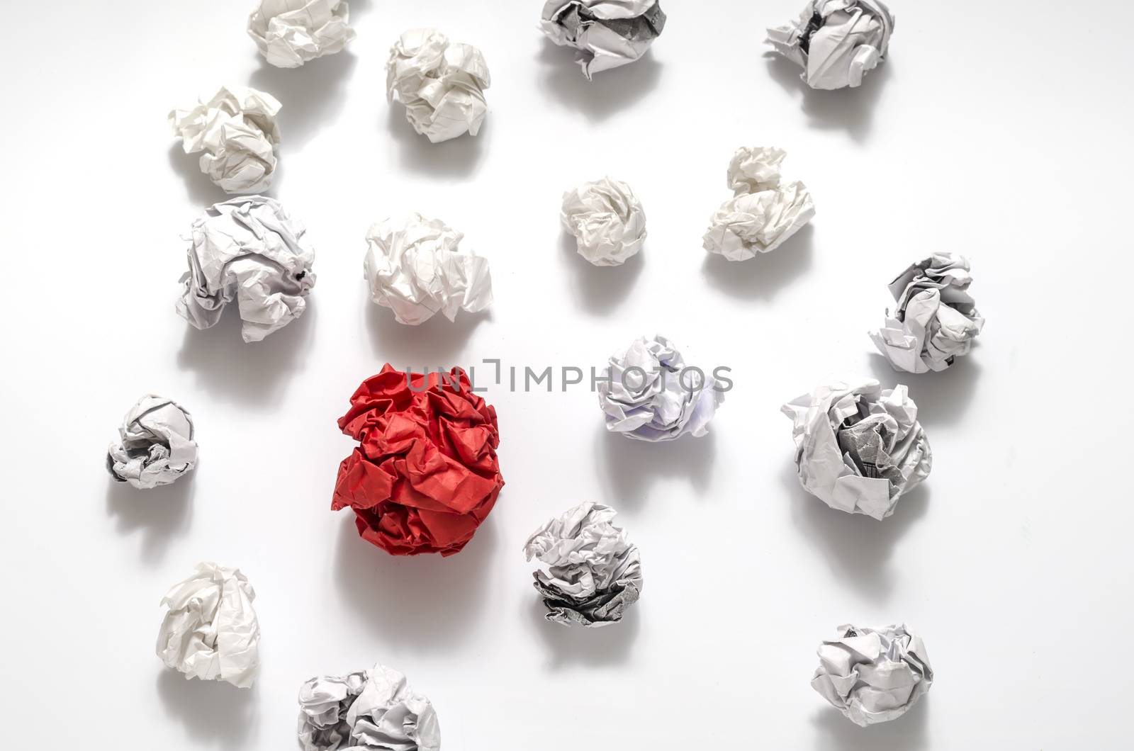 white crumpled paper ball and different red crumpled paper ball on a white background
