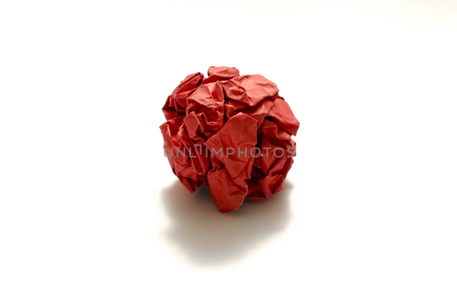 red crumpled paper ball on a white background