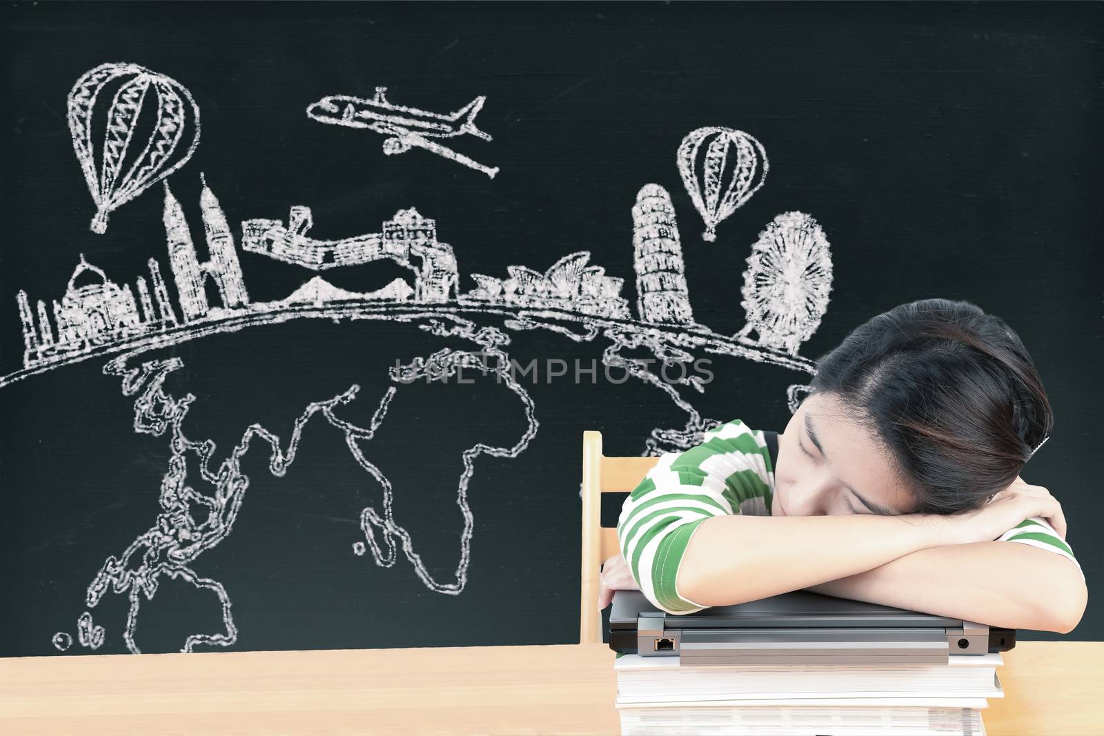 Asian woman dreaming and thinking travel holidays on blackboard by FrameAngel