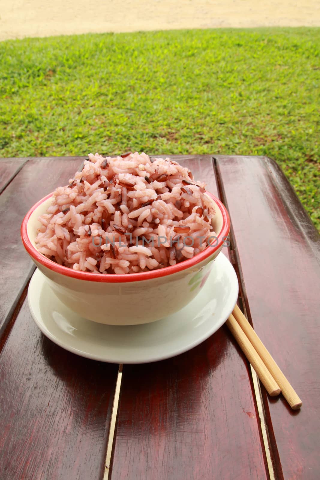 The bowl of cooked purple rice on the table.