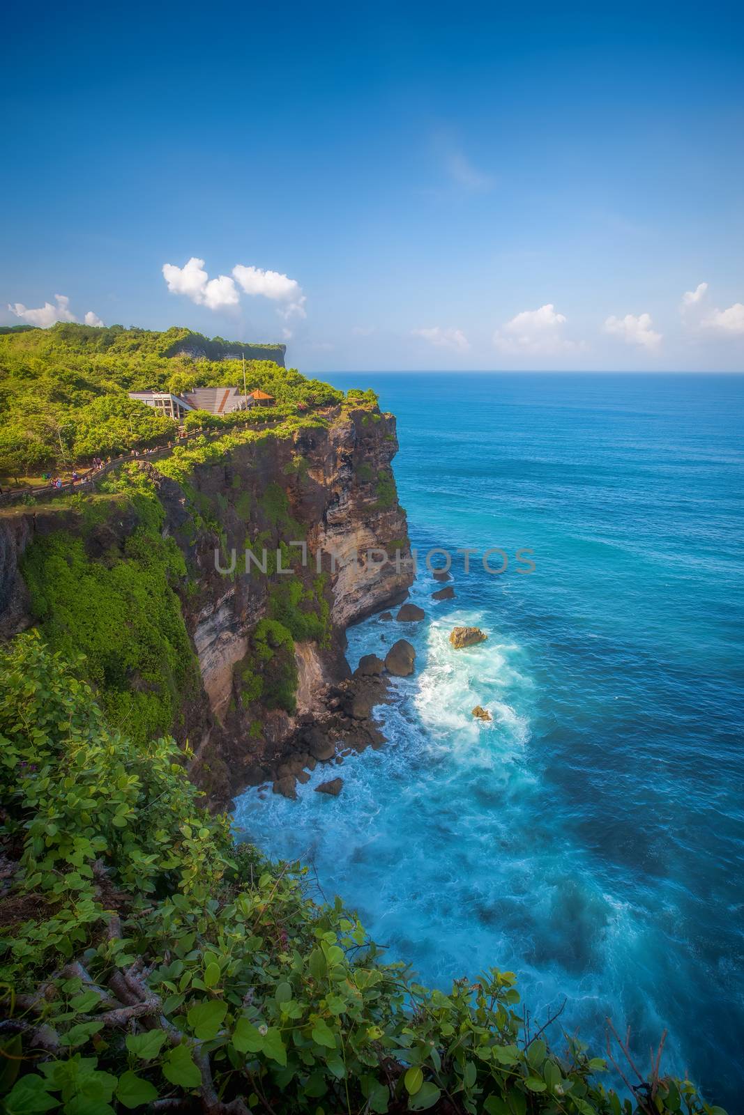 Surf waves and turqoise water along the coast of Bali