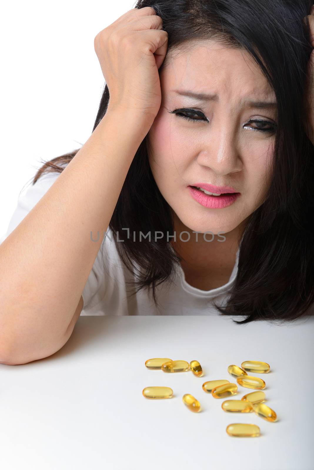 Close up Portrait of asian woman with headache and medicine on table