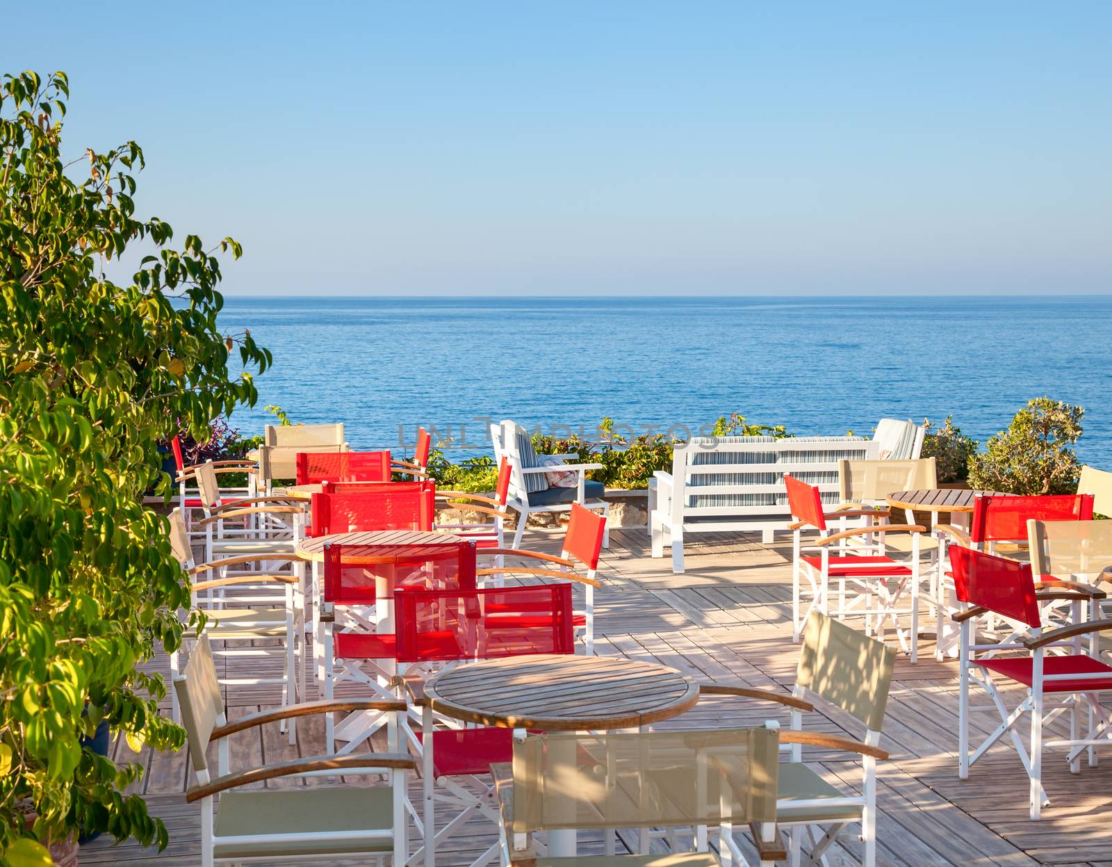 Open-air greek cafe terrace overlooking the sea