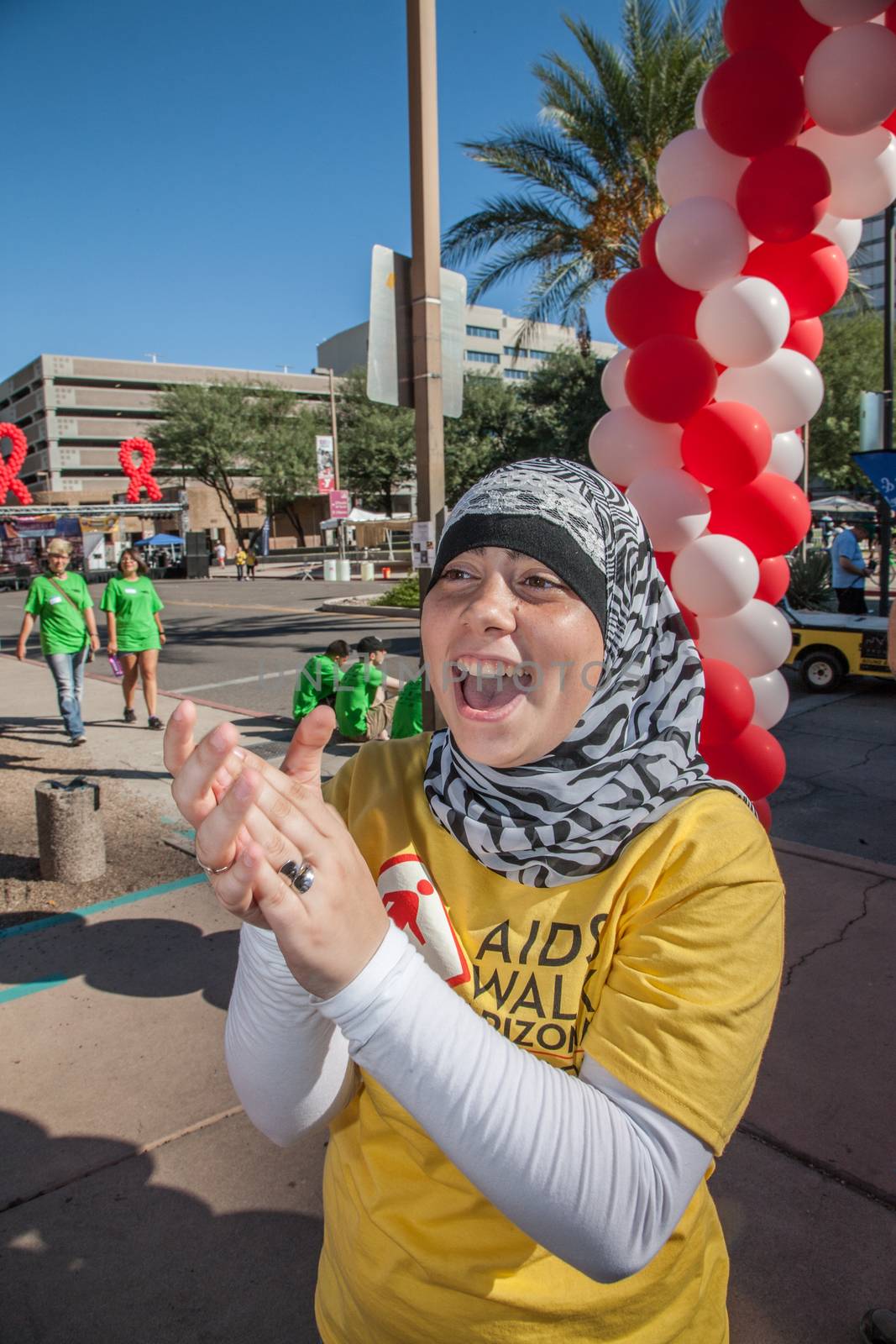 TUCSON, AZ/USA - OCTOBER 12:  Woman in head scarf ecnouraging walkers on October 12, 2014 in Tucson, Arizona, USA.