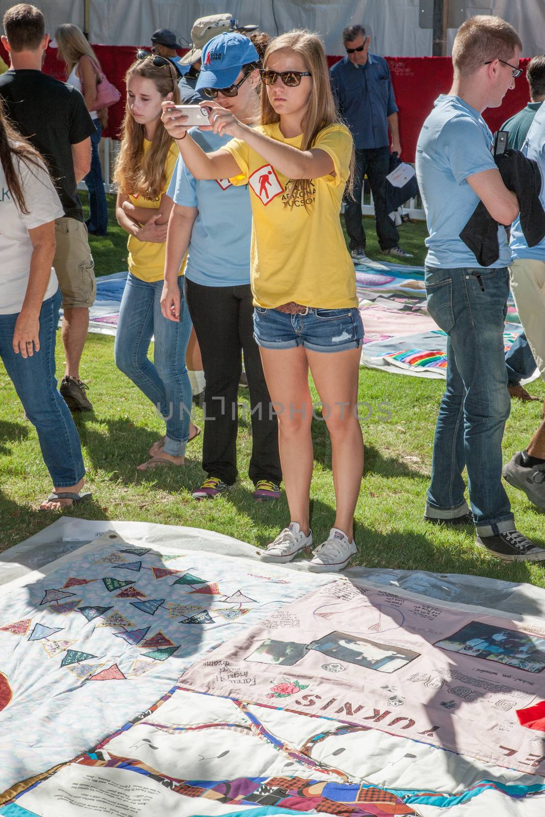 TUCSON, AZ/USA - OCTOBER 12:  Unidentifed young woman photogrph section of AIDS quilt son October 12, 2014 in Tucson, Arizona, USA.