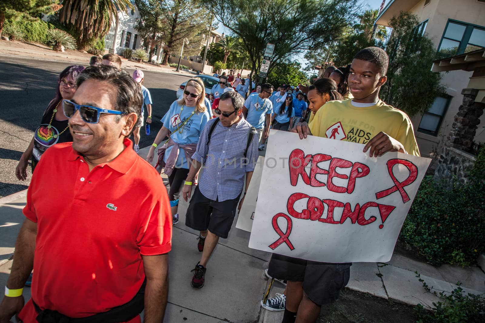 TUCSON, AZ/USA - OCTOBER 12:  Unidentified teen encouraging AIDSwalk participants on October 12, 2014 in Tucson, Arizona, USA.
