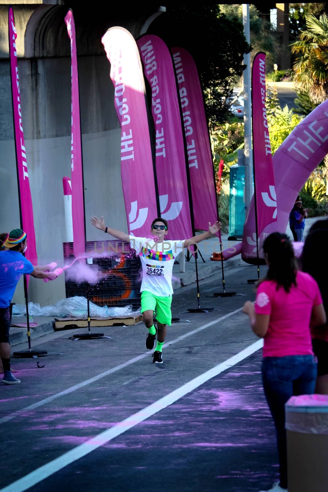 Ventura, CA - OCTOBER 18 : Participants coming through the pink color station at The Color Run 2014 in Ventura. OCTOBER 18, 2014 in Ventura, CA.