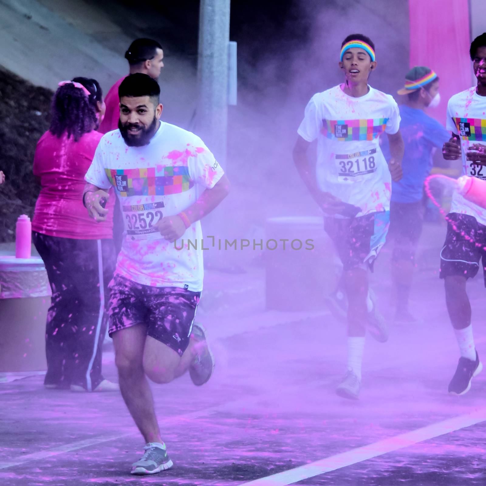 Ventura, CA - OCTOBER 18 : Participants coming through the pink color station at The Color Run 2014 in Ventura. OCTOBER 18, 2014 in Ventura, CA.