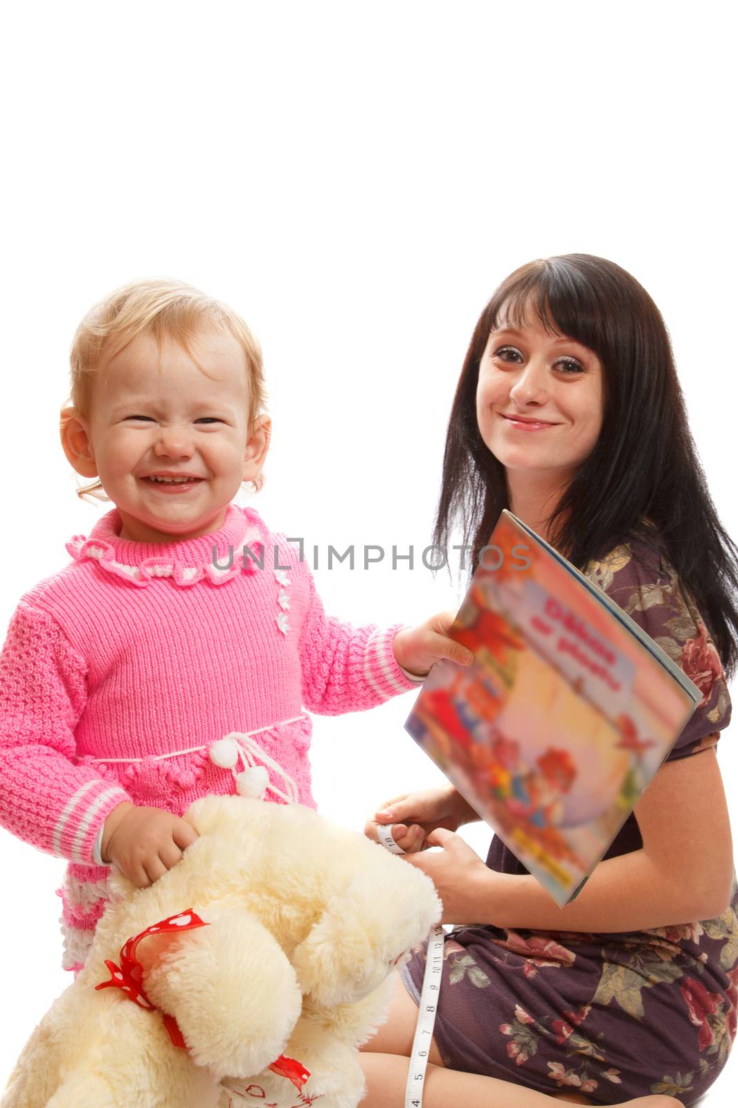 Mom and daughter playing with a toy bear and a kid book
