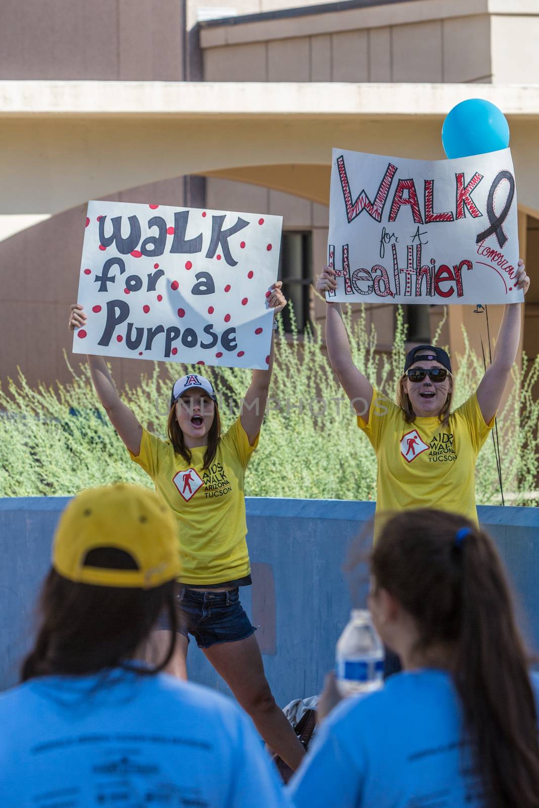 TUCSON, AZ/USA - OCTOBER 12:  Unidentified young women encouraging AIDSwalk participants on October 12, 2014 in Tucson, Arizona, USA.