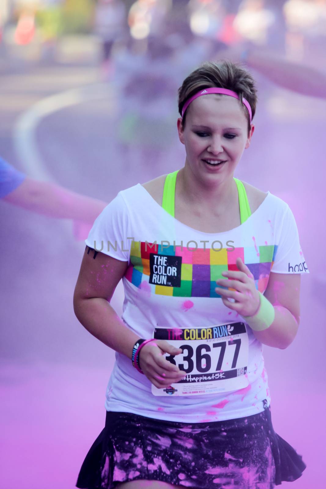 Ventura, CA - OCTOBER 18 : Participants coming through the pink color station at The Color Run 2014 in Ventura. OCTOBER 18, 2014 in Ventura, CA.