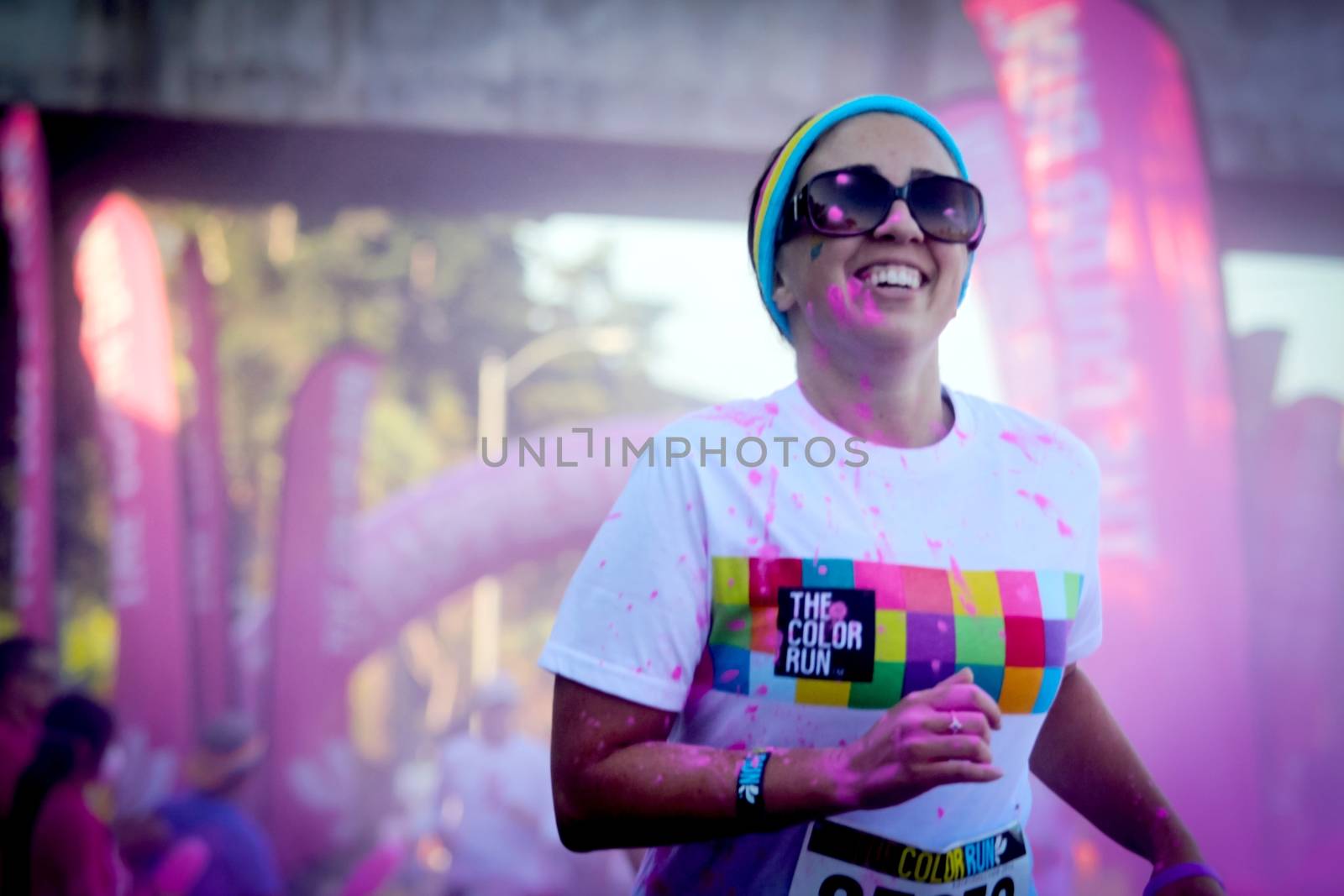 Ventura, CA - OCTOBER 18 : Participants coming through the pink color station at The Color Run 2014 in Ventura. OCTOBER 18, 2014 in Ventura, CA.