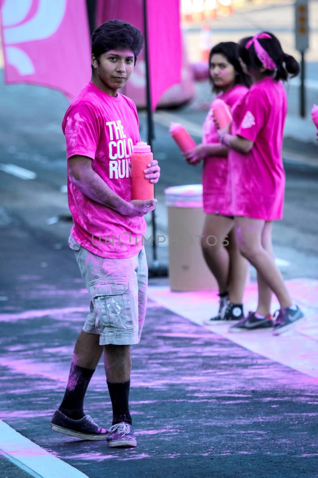 Ventura, CA - OCTOBER 18 : Participants coming through the pink color station at The Color Run 2014 in Ventura. OCTOBER 18, 2014 in Ventura, CA.