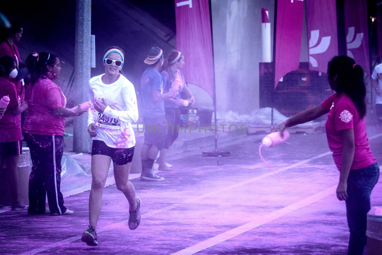 Ventura, CA - OCTOBER 18 : Participants coming through the pink color station at The Color Run 2014 in Ventura. OCTOBER 18, 2014 in Ventura, CA.