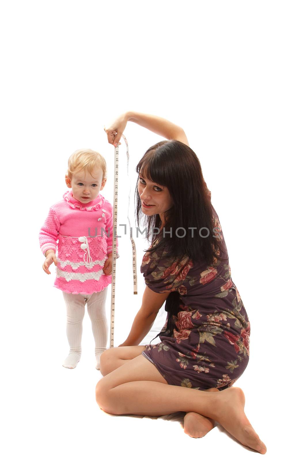 A brunette mom taking size ofher blond daughter