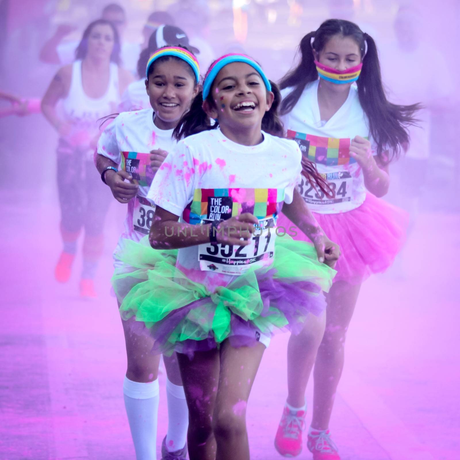 Ventura, CA - OCTOBER 18 : Participants coming through the pink color station at The Color Run 2014 in Ventura. OCTOBER 18, 2014 in Ventura, CA.