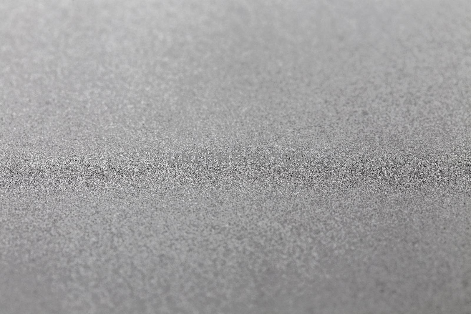 Grey silver metallic glitter shiny modern cold industrial textured background with selective focus