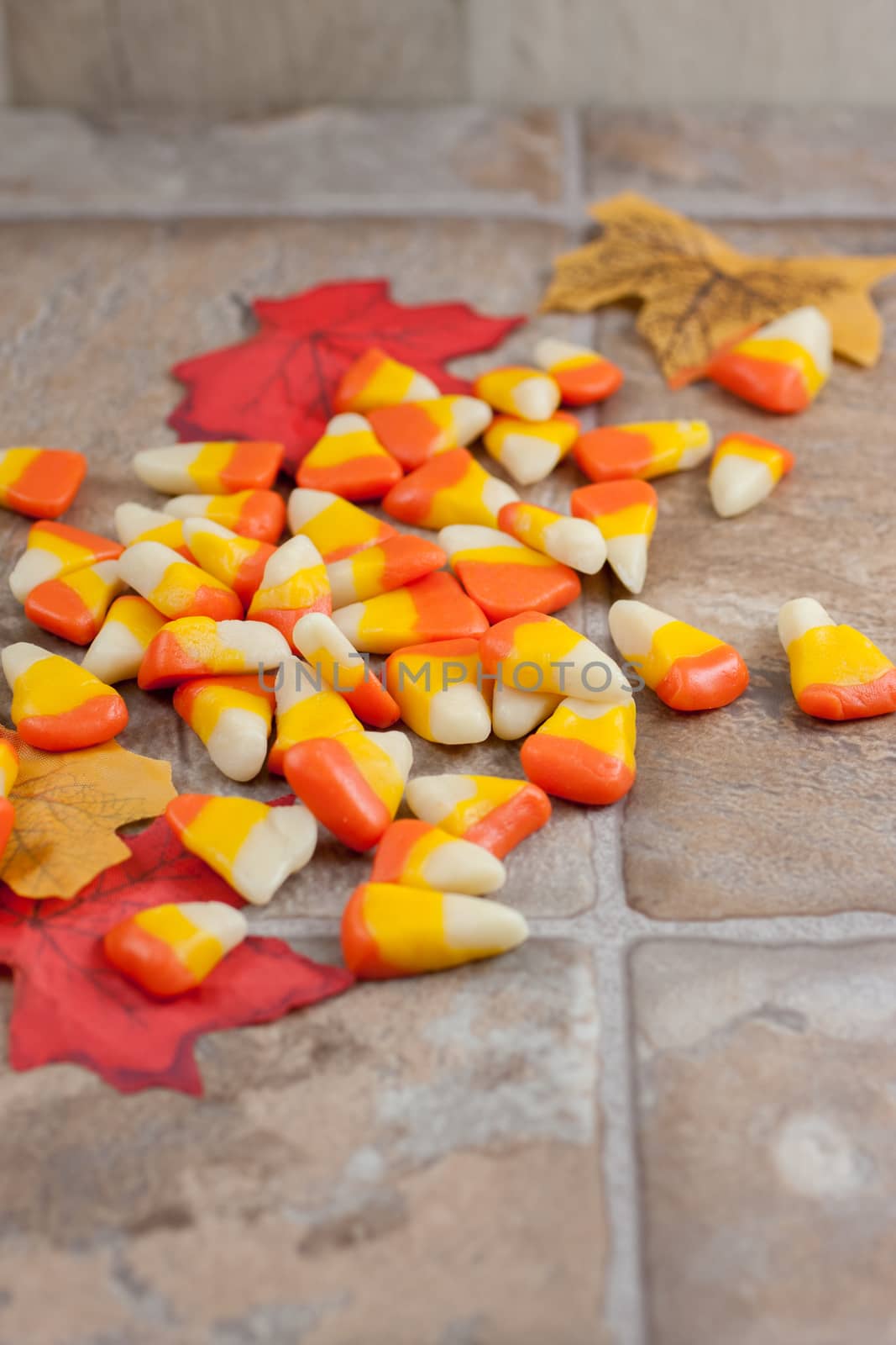 Homemade candy corn spread out accross a tile counter top.