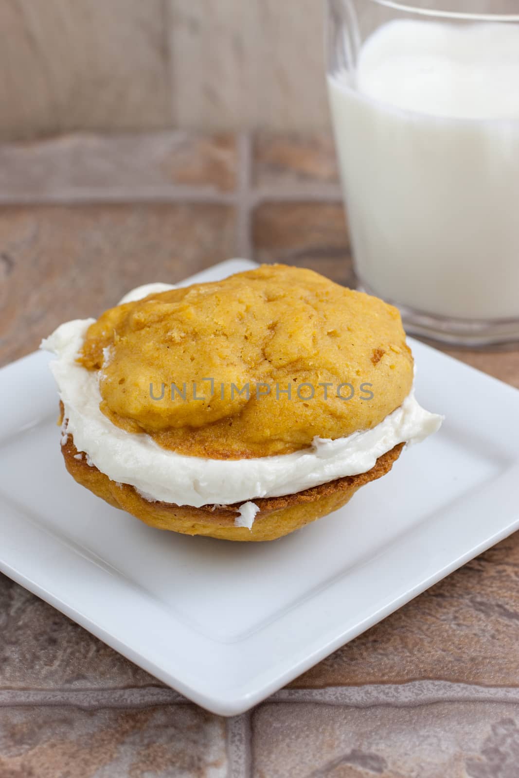 Pumpkin flavored whoopie pie cakes with whipped vanilla cream filling.