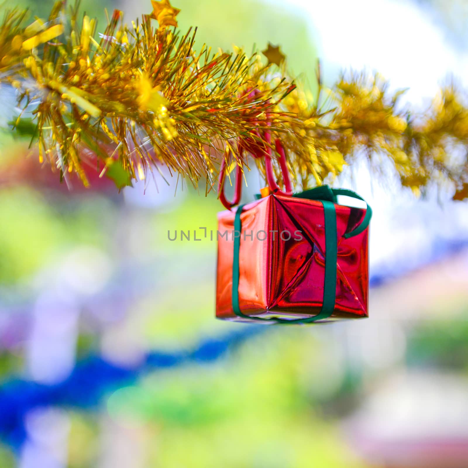 Closeup red gift box, christmas ornament hanging on tree