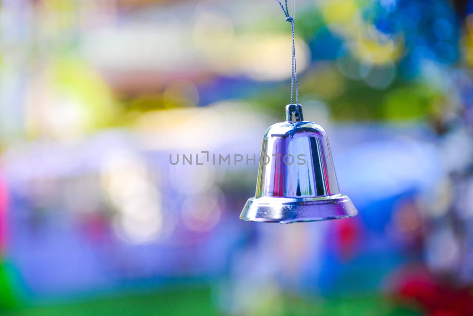 Closeup of silver bell, christmas ornament hanging on tree