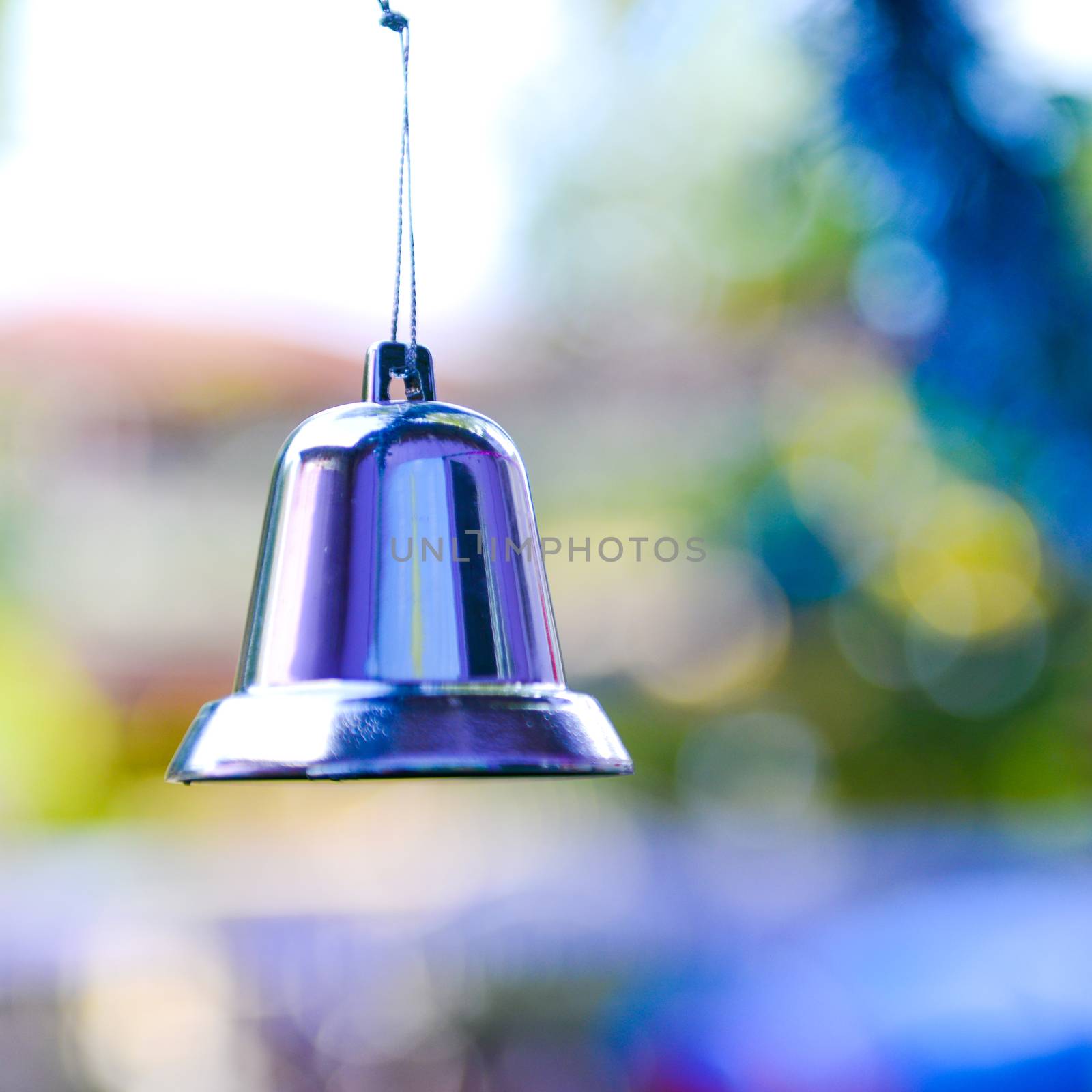 Closeup of silver bell, christmas ornament hanging on tree