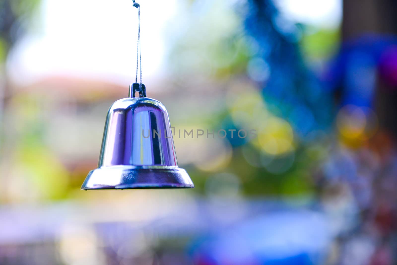 Closeup of silver bell, christmas ornament hanging on tree