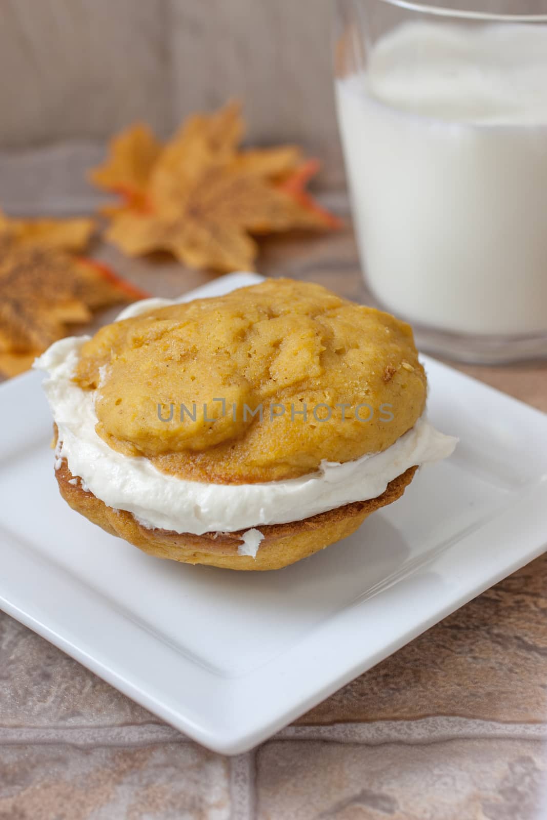 Pumpkin flavored whoopie pie cakes with whipped vanilla cream filling.