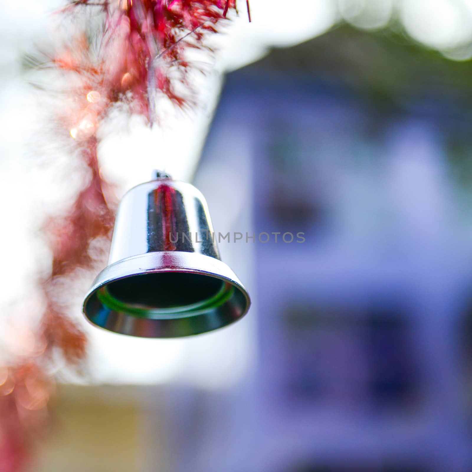 Closeup of silver bell, christmas ornament hanging on tree