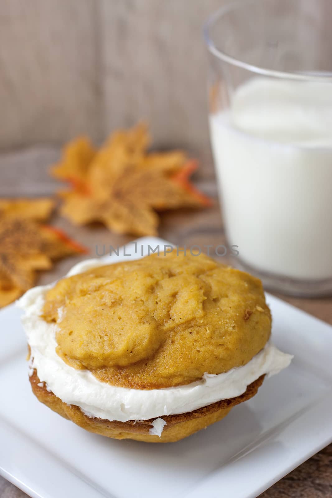 Pumpkin flavored whoopie pie cakes with whipped vanilla cream filling.