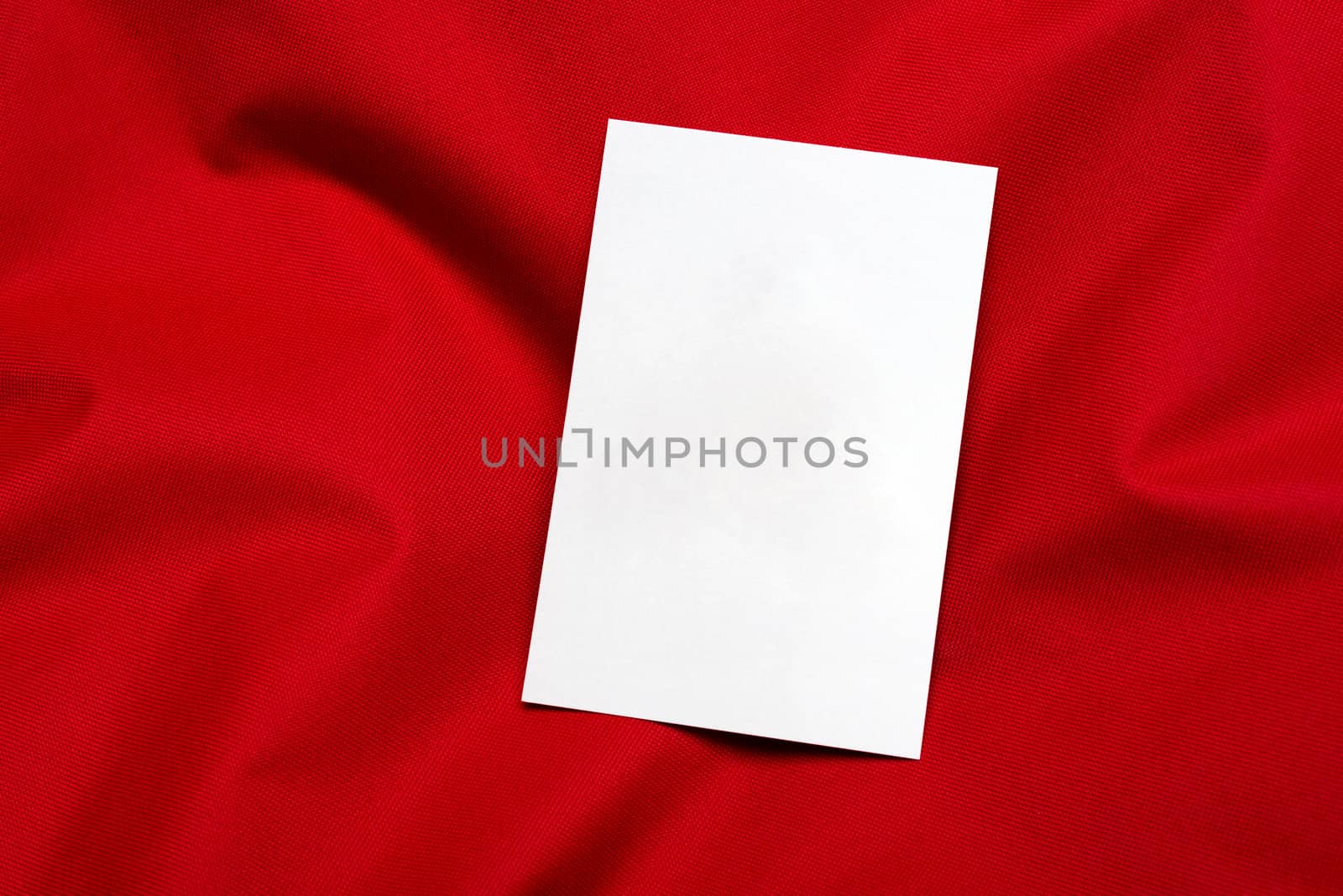 white card on red cloth
