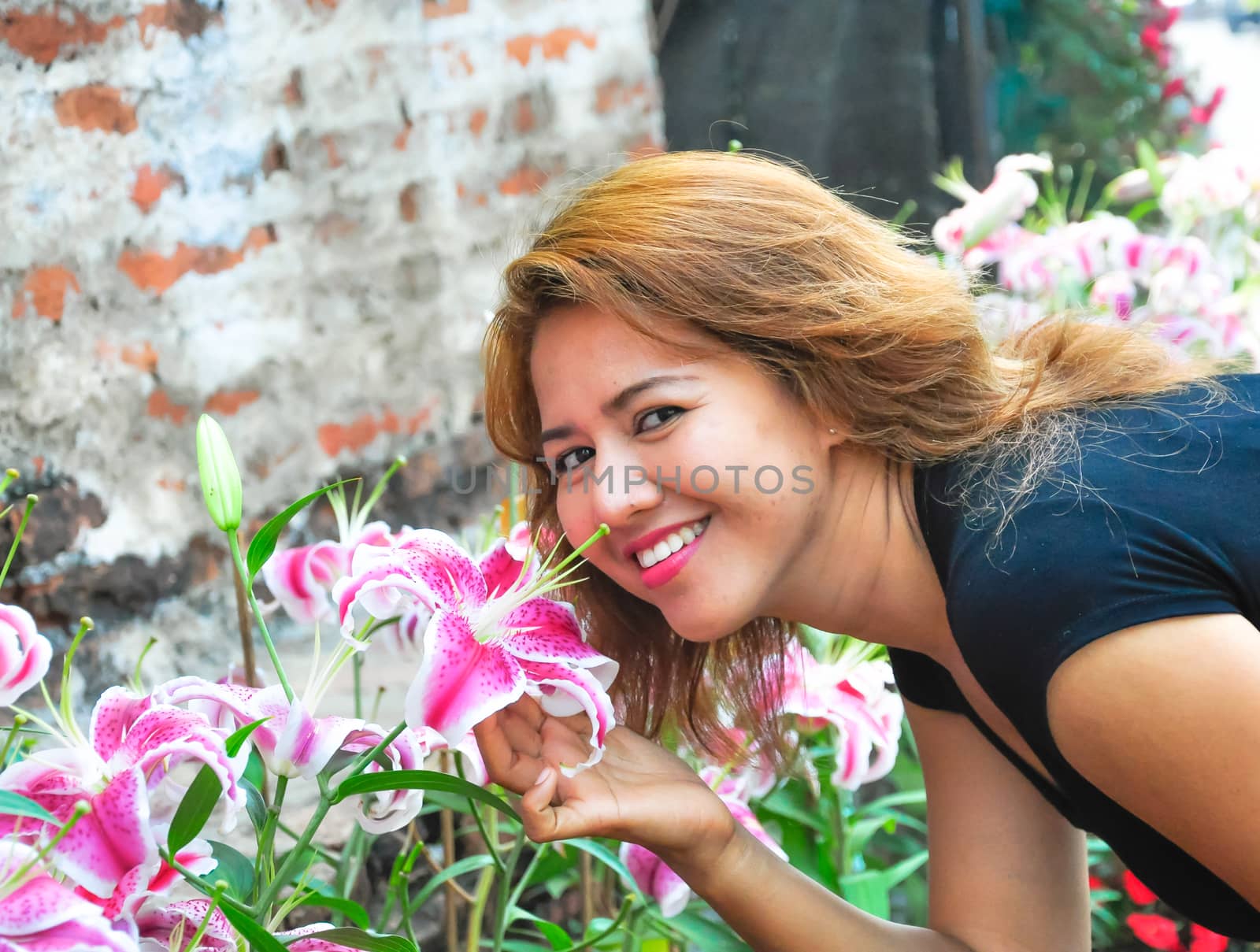 Portrait of beauty smiling pretty asian girl with beautiful flowers