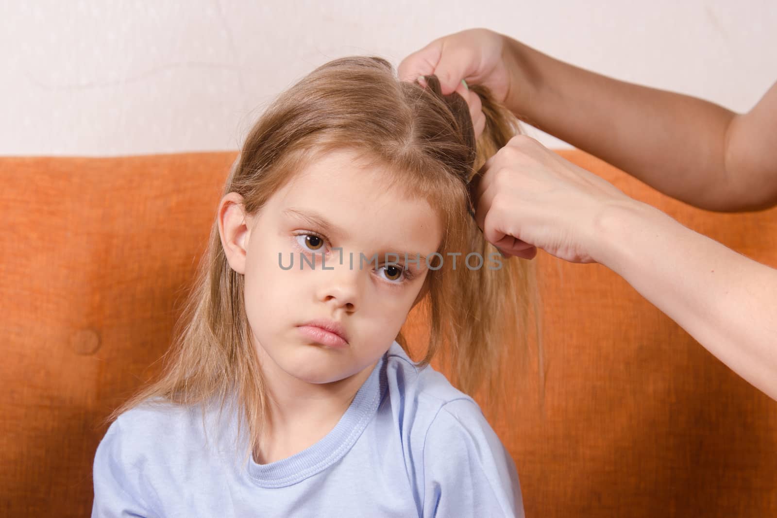 Upset five year old girl trying to get your hair braided mom